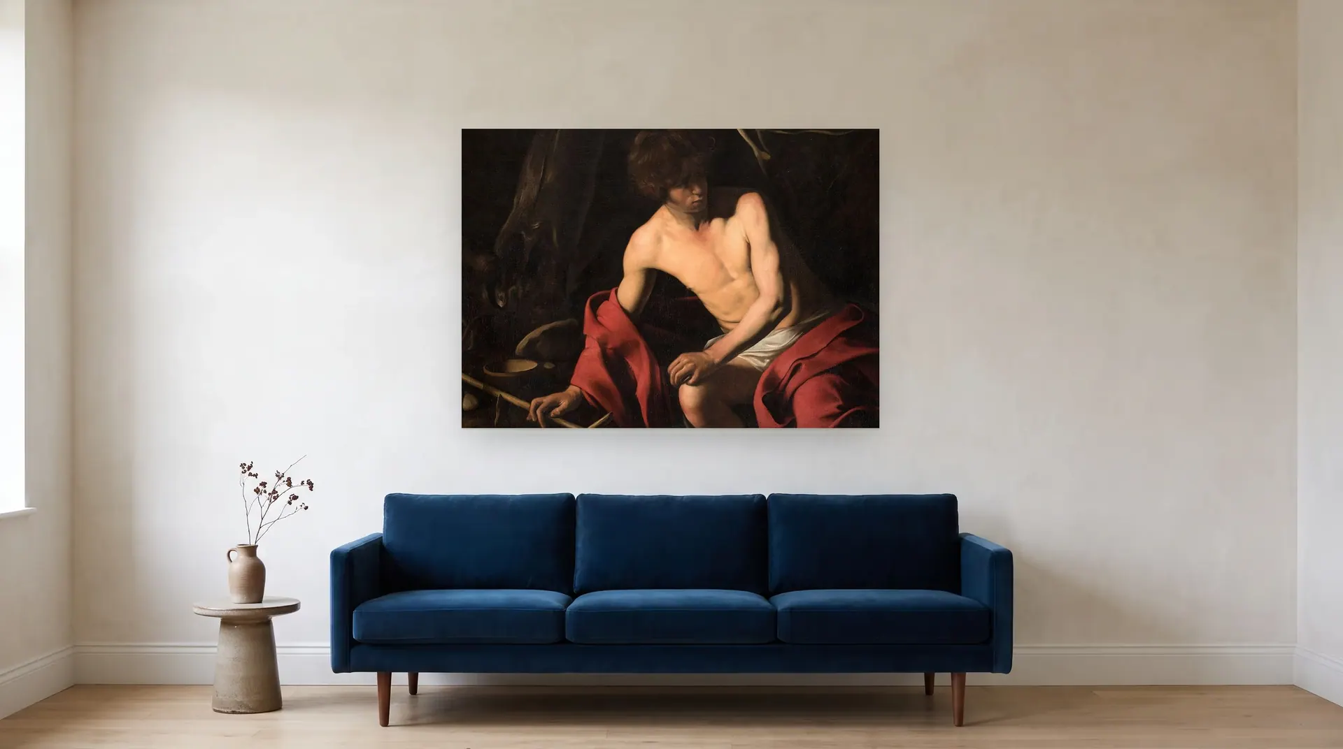 Saint John the Baptist by Caravaggio shown at its true size, 51½" × 37", over an 84" sofa