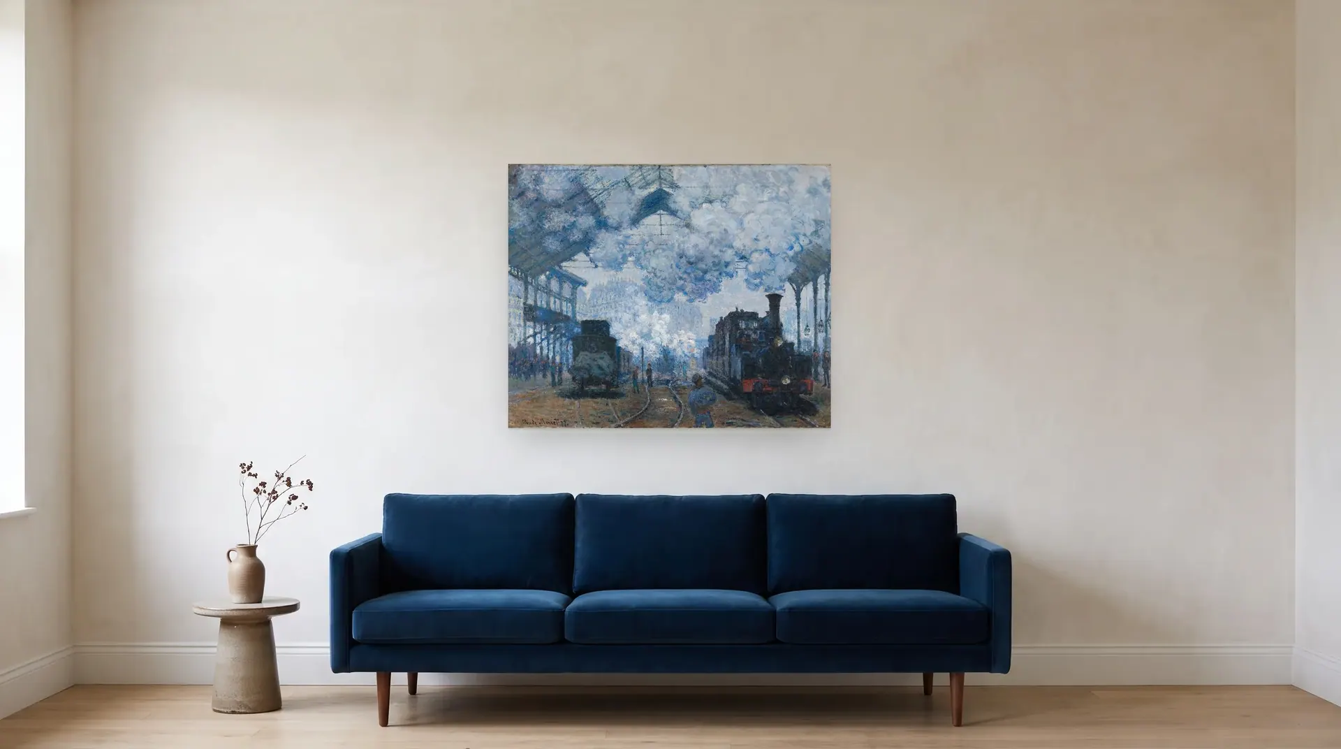 The Gare Saint-Lazare: Arrival of a Train by Claude Monet shown at its true size, 40" × 32½", over an 84" sofa