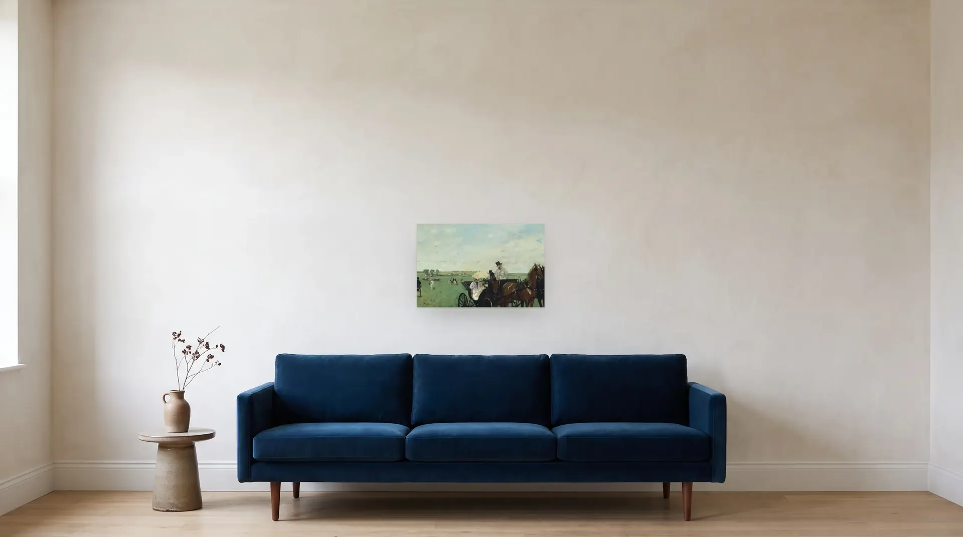 At the Races in the Countryside by Edgar Degas shown at its true size, 22" × 14½", over an 84" sofa